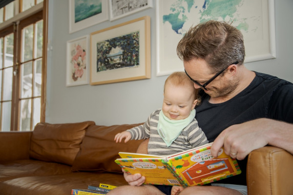 Dad reading to daughter. 