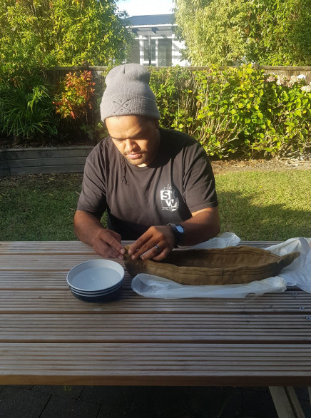 Dad making an ipu whenua. 