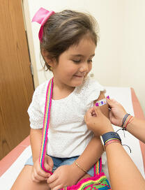 immunisation clinic girl getting vaccinated home