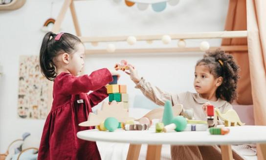 girl in red dress playing a wooden blocks 3662667