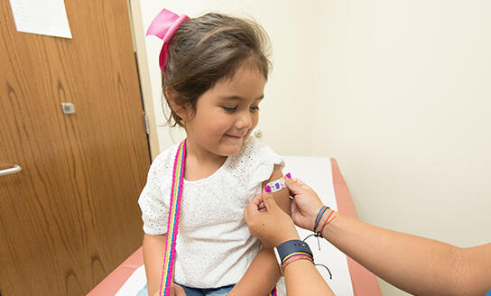 immunisation clinic girl getting vaccinated