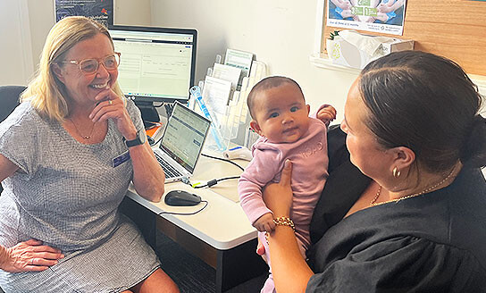 Plunket nurse with mother and baby at immunisation appointment